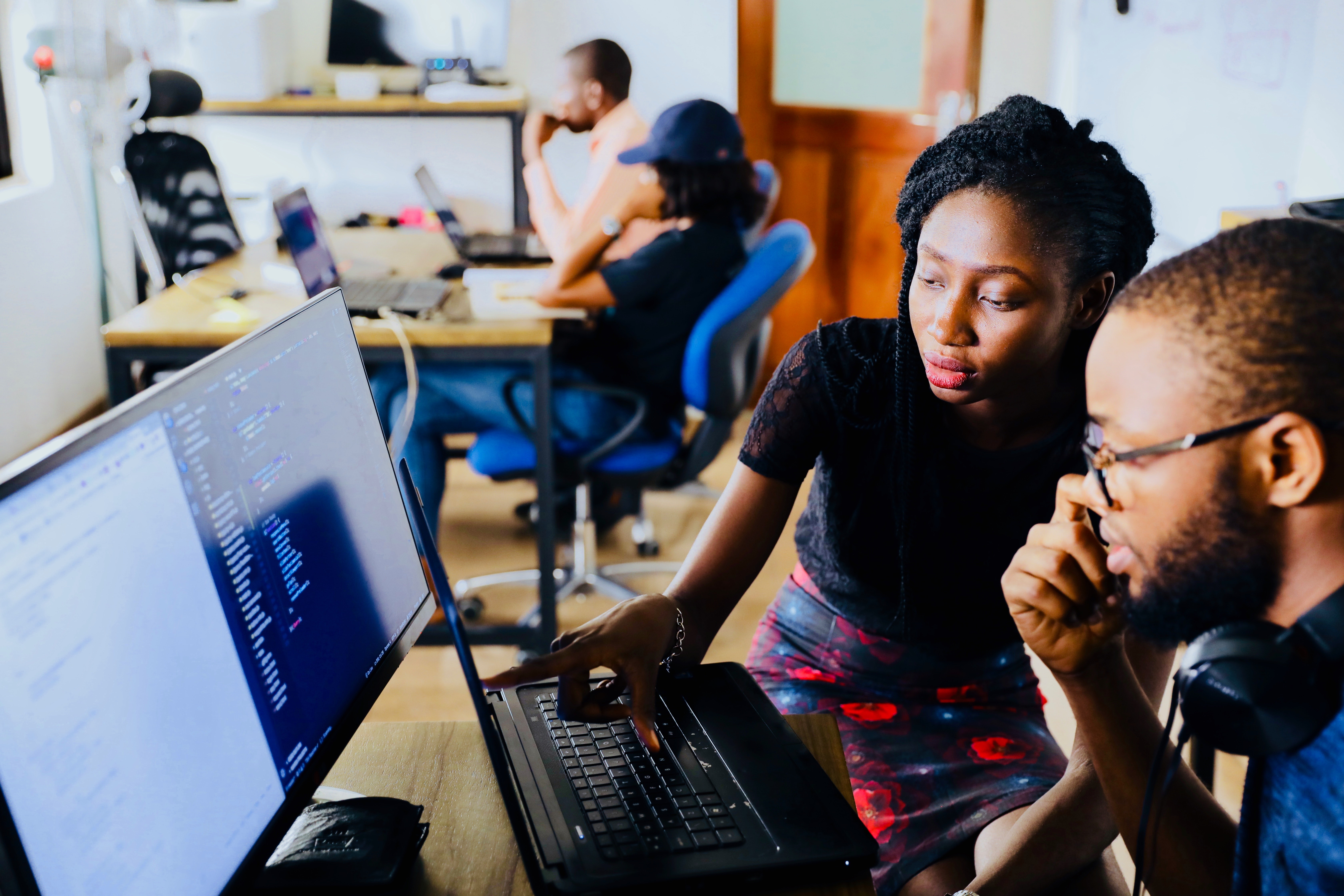 Stock photo of two people collaborating on a computer